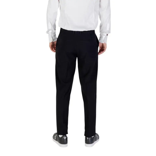 Men’s black trousers with white dress shirt and black sneakers from Armani Exchange