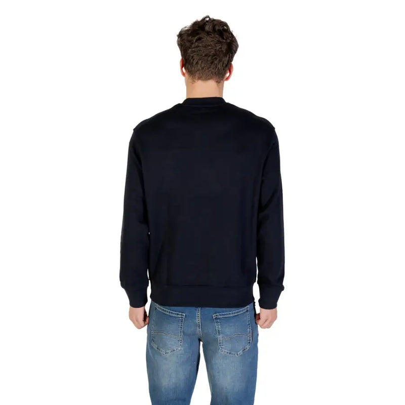 Men’s navy blue cotton crewneck sweatshirt paired with blue jeans from Armani Exchange