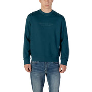 Men’s dark teal long-sleeve crewneck sweatshirt paired with blue jeans from Armani Exchange