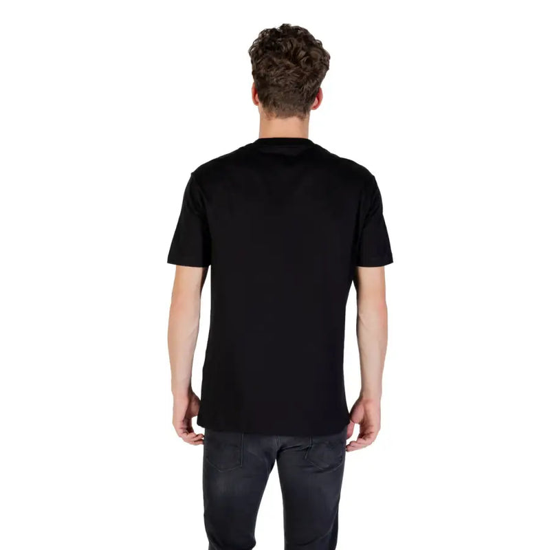 Men’s black cotton short-sleeve round neck T-shirt from Armani Exchange displayed with dark pants