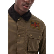 Man wearing olive-green Barbour blazer with US and UK flag patch and front pockets