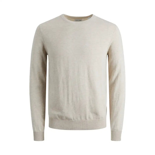 Beige crew-neck sweater displayed with dark blue jeans on a model