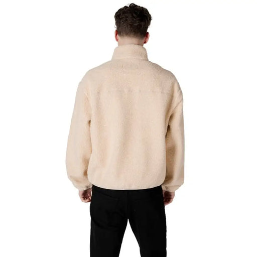 Beige fleece jacket featured in Calvin Klein Jeans Men’s Turtleneck Zip Sweatshirt