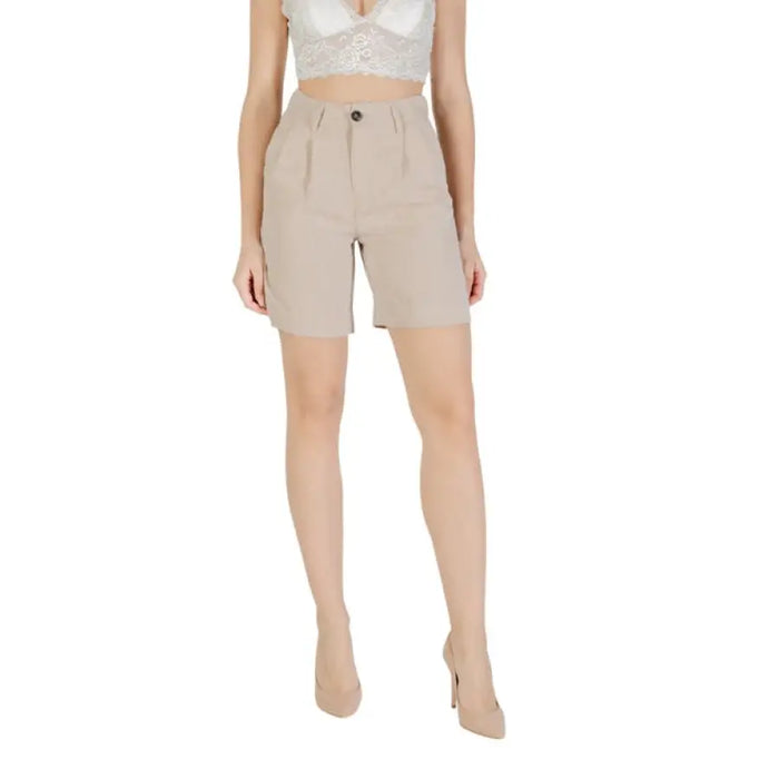 Beige high-waisted shorts and top for women displayed in a fashion catalog