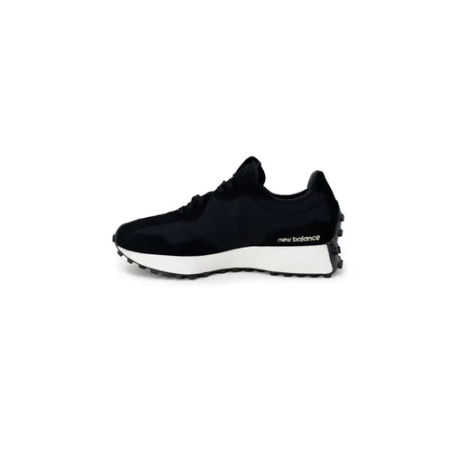 Black New Balance women’s sneakers with faux leather upper, white midsole, and black rubber lugged outsole