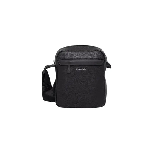 Black Calvin Klein crossbody bag displayed on a neutral background