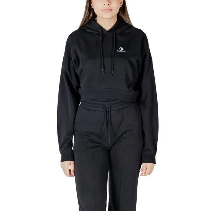 Black Converse cropped hoodie and pants set displayed in a modern fashion store