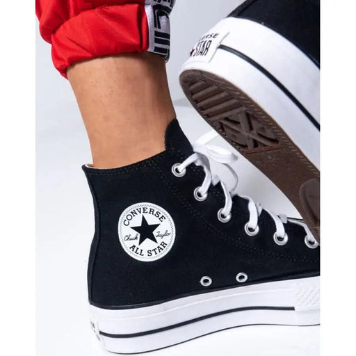 Black Converse platform sneakers with print and laces for women, stylish footwear choice