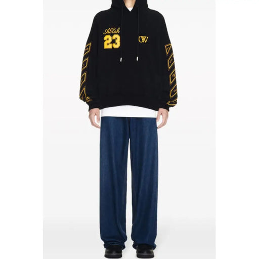 Black hoodie with yellow accents displayed, stylish and comfortable clothing option