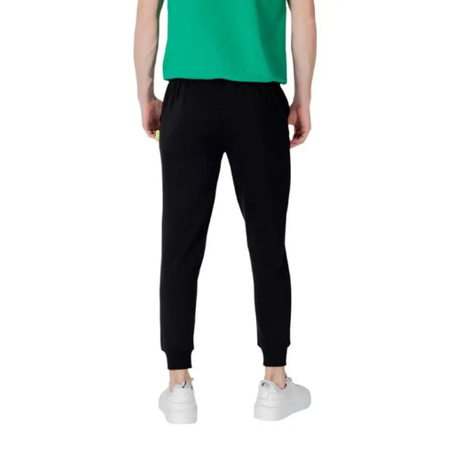 Black jogger pants with white drawstring and ICON print for a casual athletic look