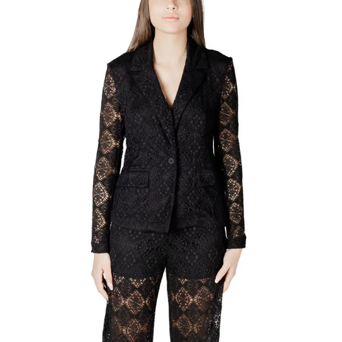 White lace blazer and pants set displayed, featuring elegant black lace detailing