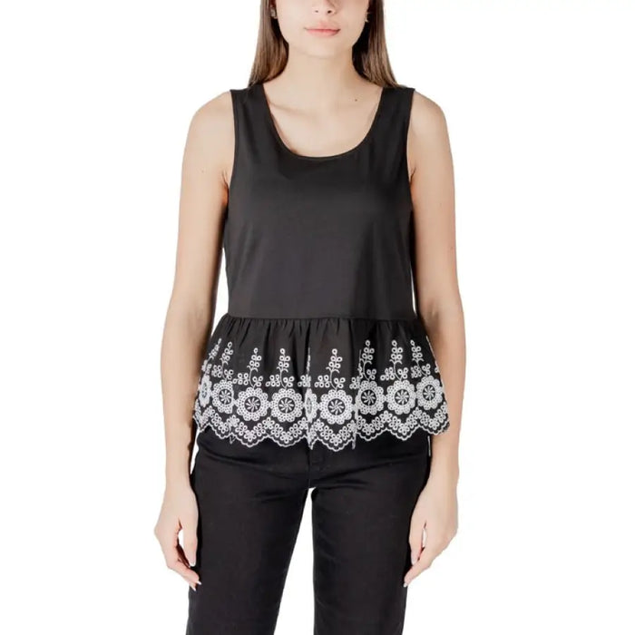 Black sleeveless top with white embroidered trim featured in White Sleeveless Top with Black Floral Trim product