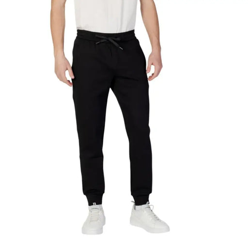 Black drawstring sweatpants from Armani Exchange Men featuring a plain design