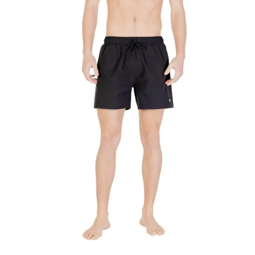 Black swim trunks displayed in a product image for men’s swimwear