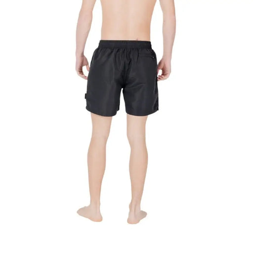 Black swim trunks with a white logo for men’s swimwear, pool or beach use