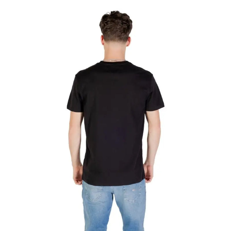 Black T shirt with square logo paired with blue jeans from Tommy Hilfiger