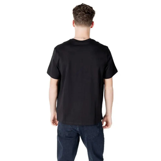 Black Calvin Klein T shirt paired with dark blue jeans for a stylish casual look