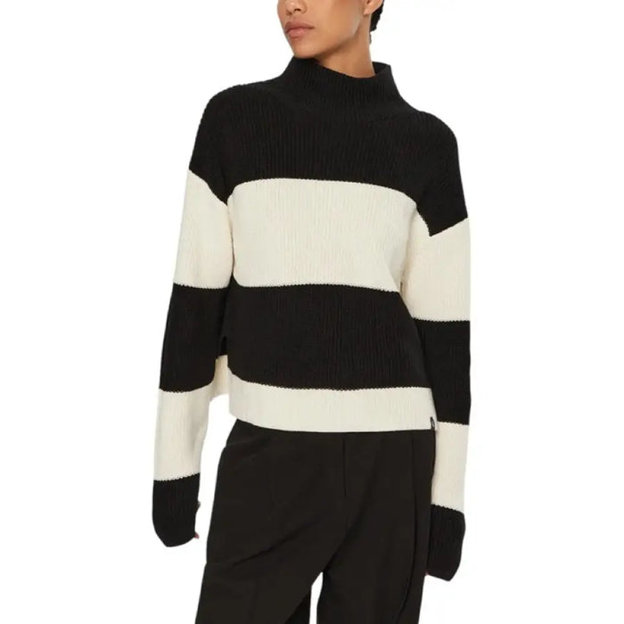 Black and white striped turtleneck sweater displayed on a clothing mannequin