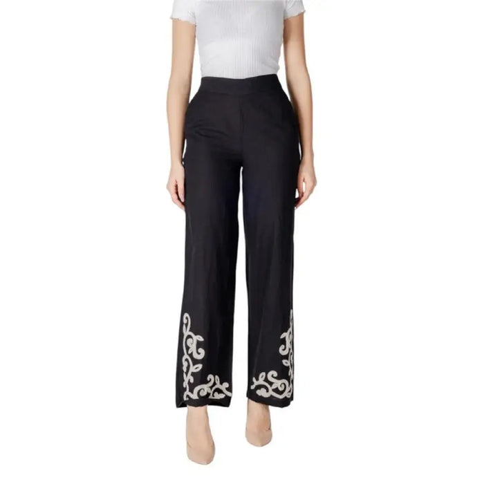 Black wide leg pants featuring elegant white embroidery for stylish comfort