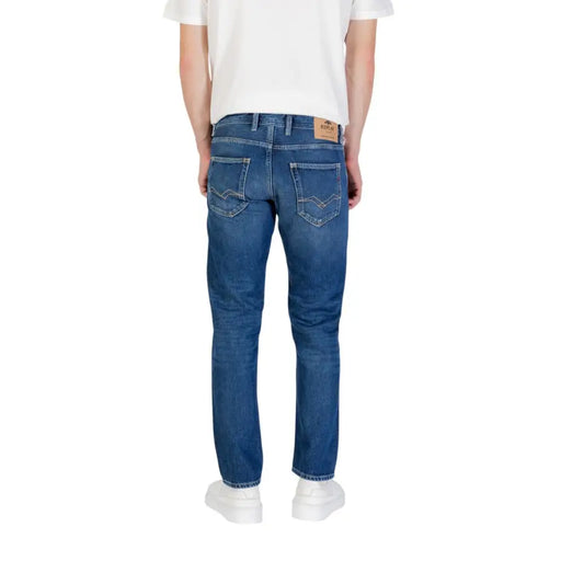 Blue denim jeans displayed with white sneakers on a product page
