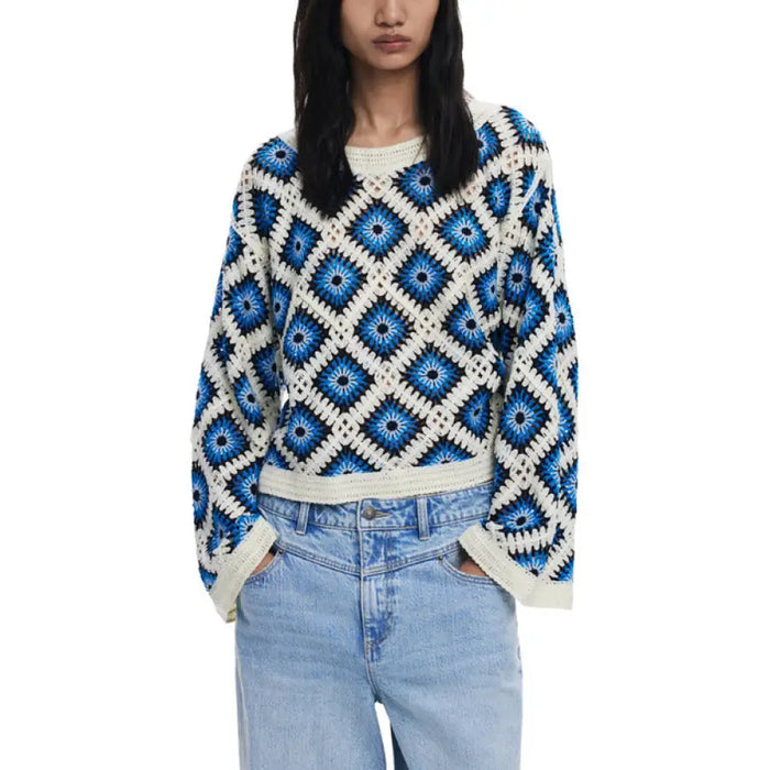 Blue and white crocheted sweater styled with wide leg jeans, fashionable and cozy attire