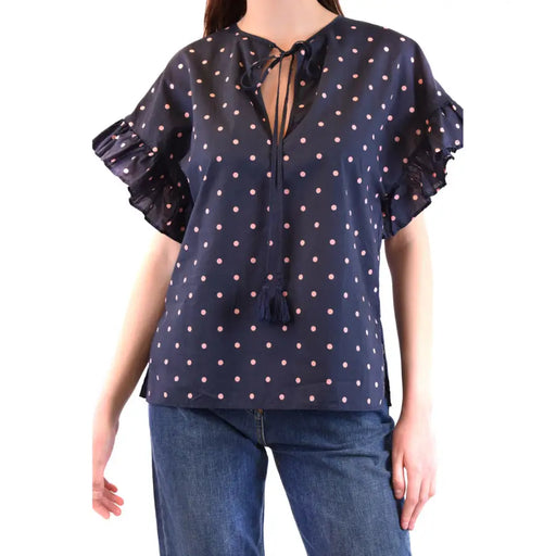 Navy blue women’s blouse with pink polka dots, ruffled sleeves, and tassel-tie V-neck