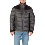 Black and brown puffer jacket with zipper, fur lining, and patch on chest.