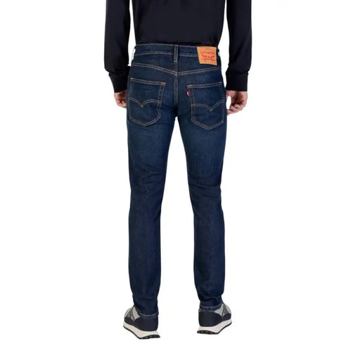 Dark wash denim jeans for men displayed prominently in a product image