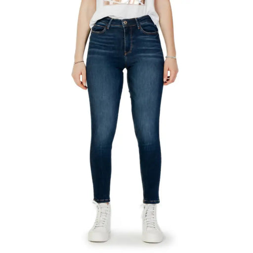 Dark wash skinny denim jeans displayed on a retail model, showcasing modern fashion style