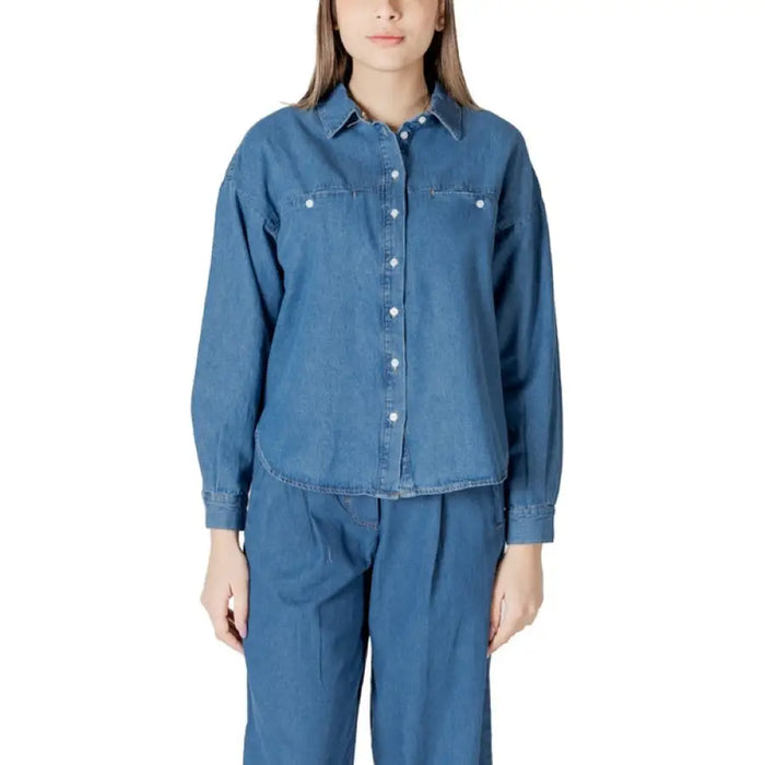 Denim button-down shirt and pants set displayed in a product image