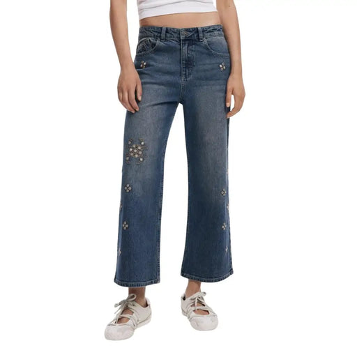 Women’s mid-wash wide-leg denim jeans with floral embellishments and rhinestone details