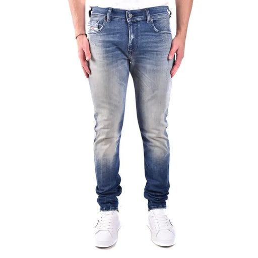 Slim fit blue denim jeans with distressed details and white sneakers.
