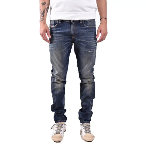 Slim fit blue denim jeans with distressed details and a popular brand logo.