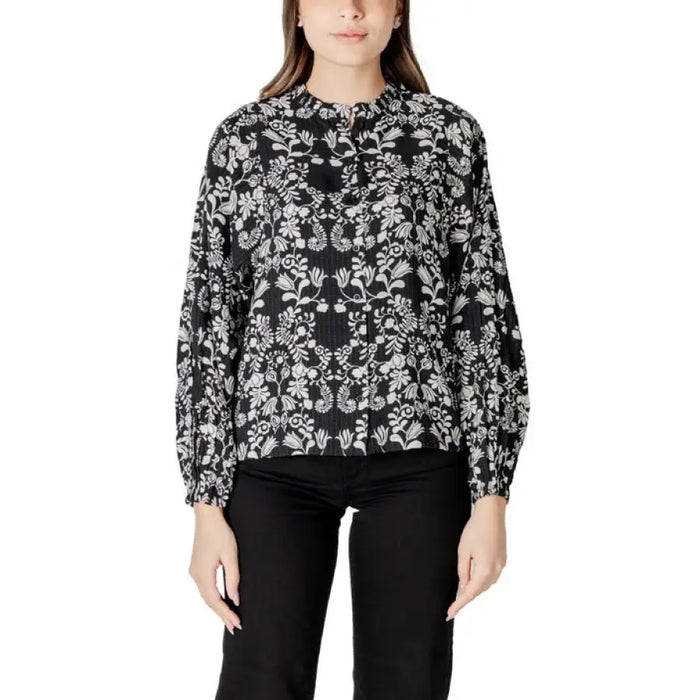 Women’s black and white floral print long-sleeved blouse displayed in the product image