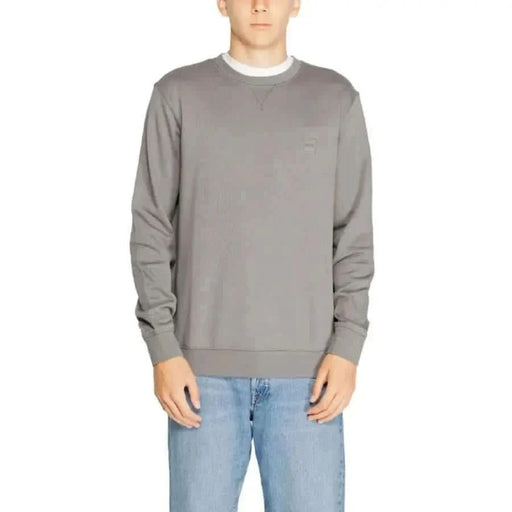 Gray crewneck sweatshirt modeled by a person from Boss Men Knitwear