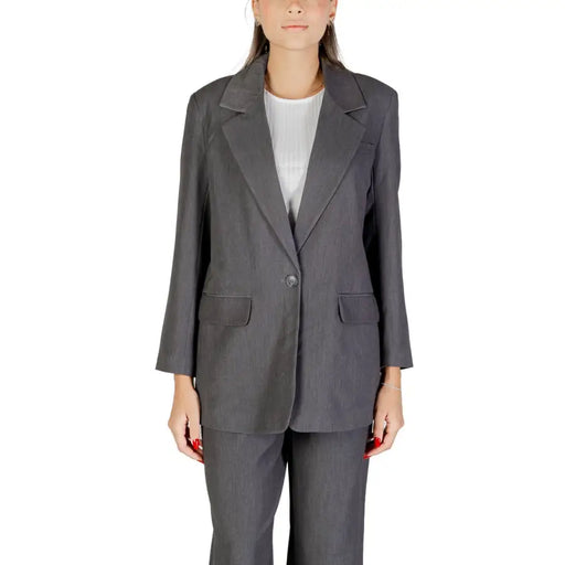 Dark gray women’s two-piece suit with single-button blazer and matching trousers for fall winter