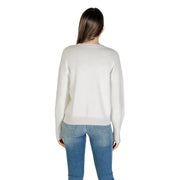 Woman wearing Guess White Printed Viscose Blend Round Neck Knit Sweater and Blue Jeans