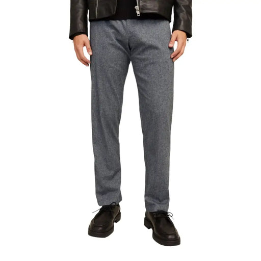 Men’s gray patterned cotton stretch trousers with black leather jacket and dark brown dress shoes