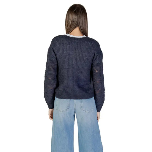 Women wearing Jacqueline De Yong long blue V neck knit sweater with light wash wide-leg jeans