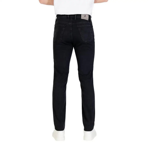 Black slim fit jeans with a belt loop and button closure.