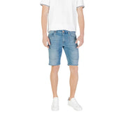 Blue denim shorts with rolled hem and white sneakers.