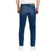 Slim fit blue jeans with a dark wash and brown leather patch at the back pocket.