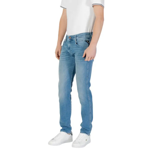 Light blue denim jeans shown with white sneakers in a men’s fashion product display