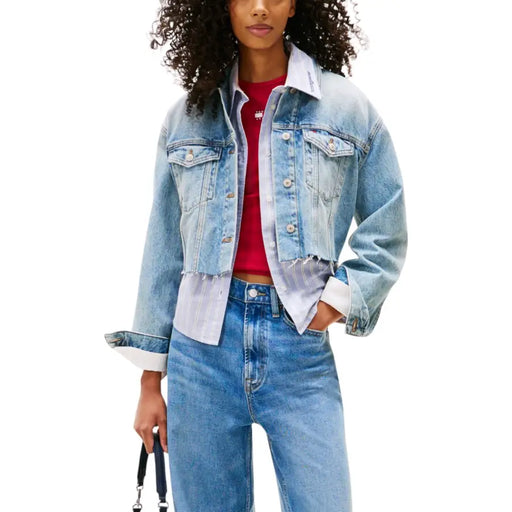 Light blue printed long womens blazer layered with a light wash denim jacket over a red top and white collared shirt