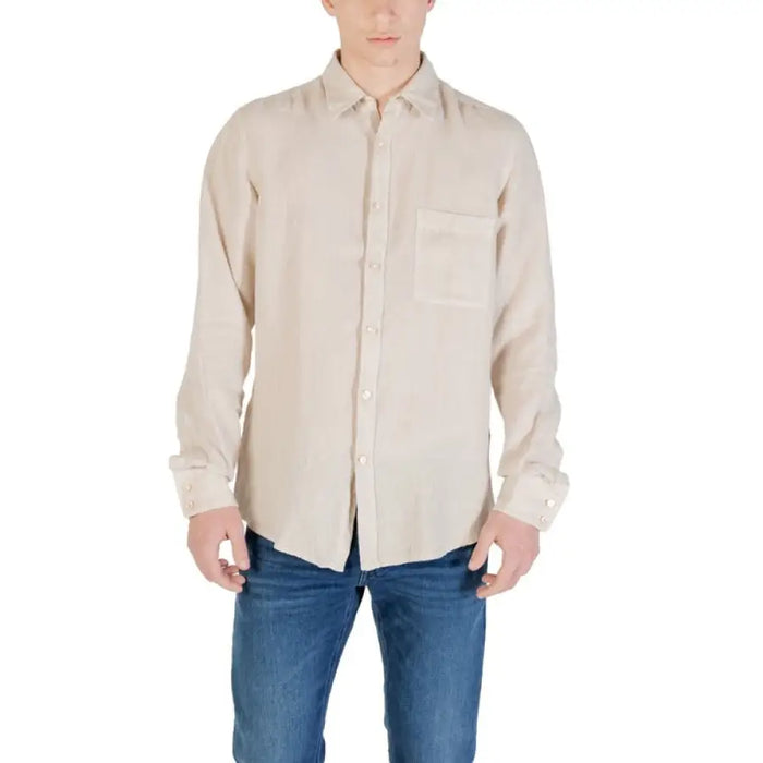 Man wearing a beige button-down shirt for men, stylish and casual wear