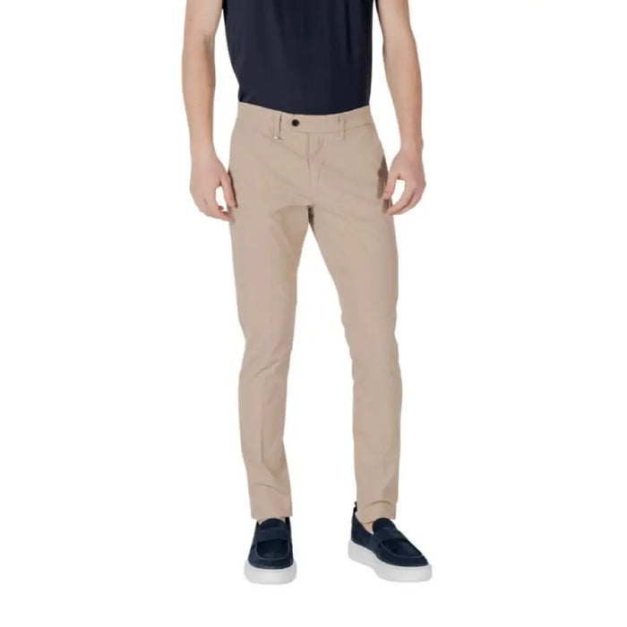 Man wearing beige slim-fit trousers from Tan Slim-Fit Trousers for Men collection