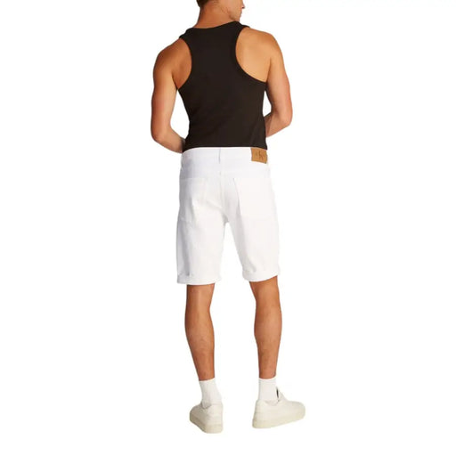 Man wearing black tank top and white denim shorts for Men’s Black Tank Top and White Denim Shorts product