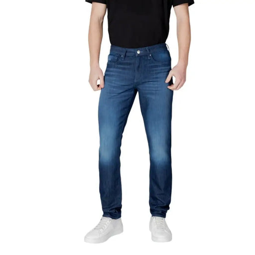 Man in blue jeans and white sneakers wearing Armani Exchange Blue Mens Jeans Spring Summer