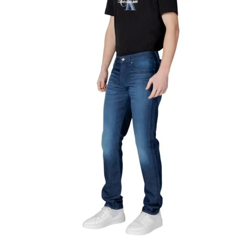 Man wearing Armani Exchange Blue Mens Jeans with white sneakers in casual setting