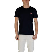 Man wearing a dark blue T-shirt and white pants showcasing Guess Men’s White Round Neck T-Shirt